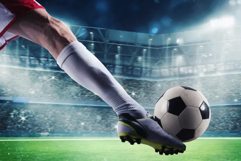 Soccer player holding a soccer ball at a stadium